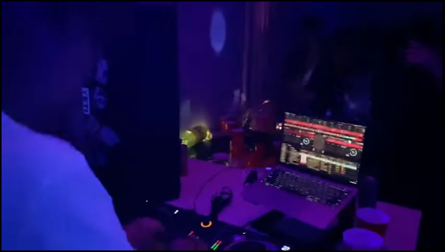 A packed dancefloor lit from the booth during a LÜMEN set